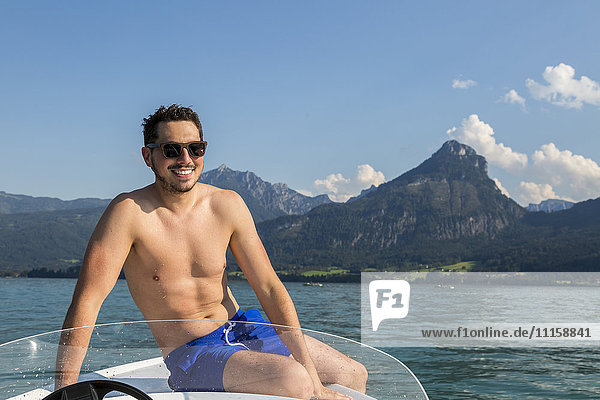 Austria  Sankt Wolfgang  man sitting on boat in lake