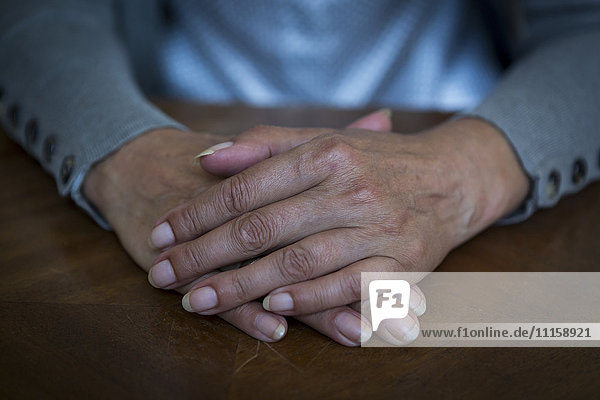 Woman's hands on tabletop  close-up