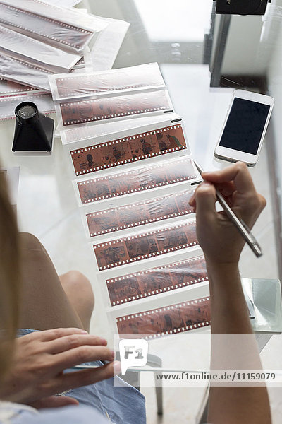 Woman labeling film strips