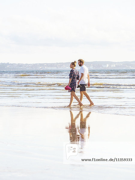 Couple talking a beach walk