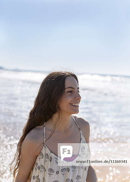 Happy young woman on the beach