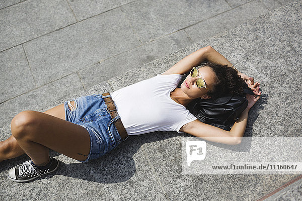 Relaxed young woman lying down enjoying the sunshine
