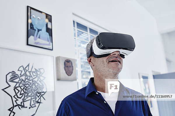 Mature man wearing virtual reality glasses