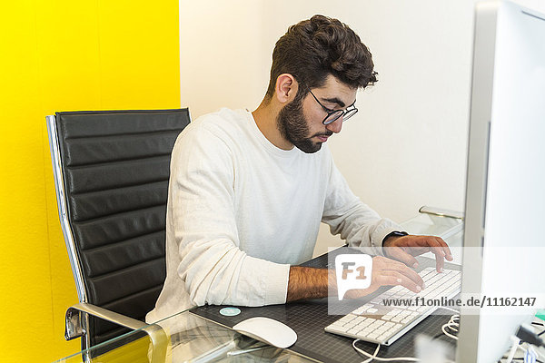 Young man working with computer in an office