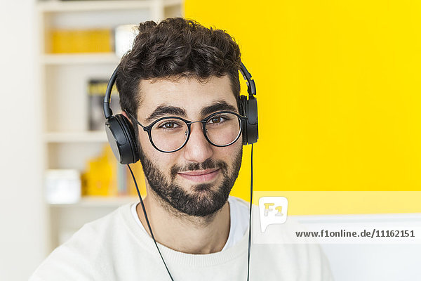 Portrait of smiling man with glasses and headphones