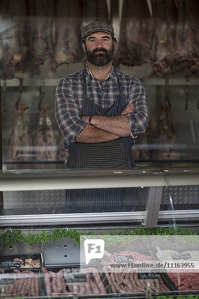 Portrait of confident butcher in butchery