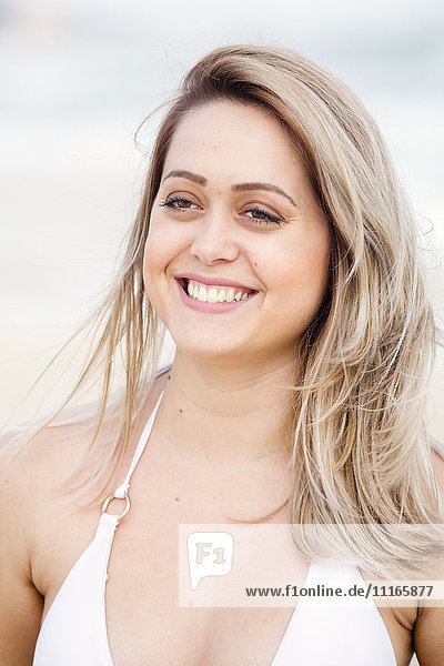 Smiling Mixed Race woman wearing bikini