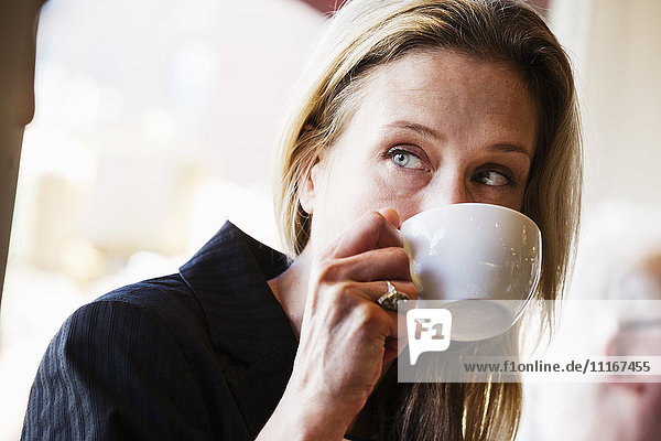 Businesswoman drinking a cup of coffee.