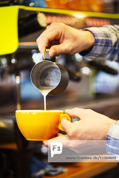 Close up of a barista making a cup of espresso.