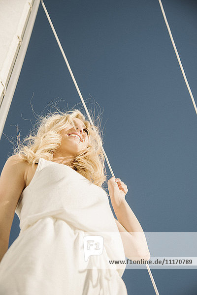 Blond teenage girl on a sail boat.