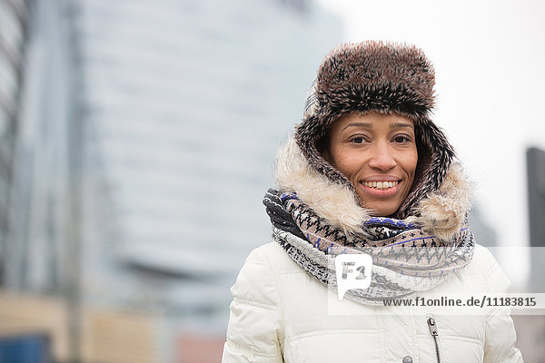 Portrait of happy woman in warm clothing outdoors