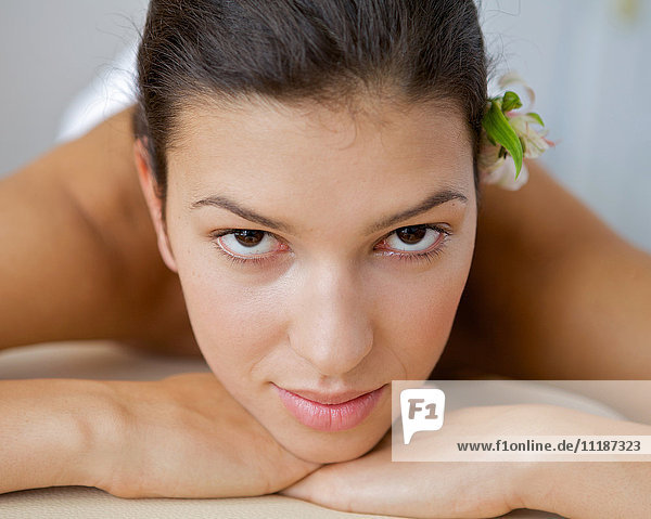 Close-up of young woman relaxing on massage table