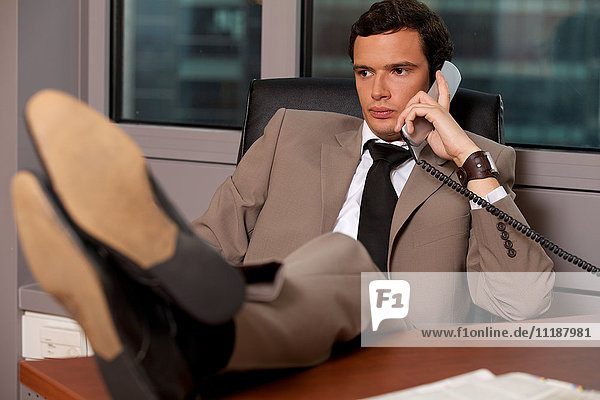 Businessman talking on telephone in an office