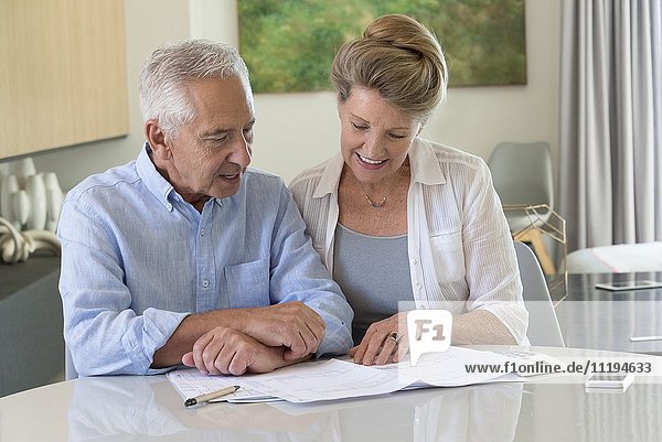 Senior couple doing paperwork at home