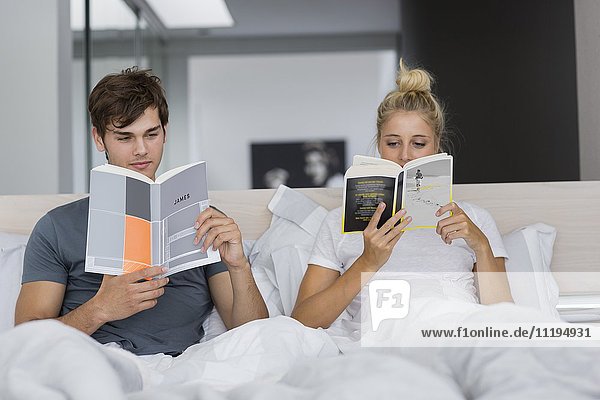 Couple reading books on the bed