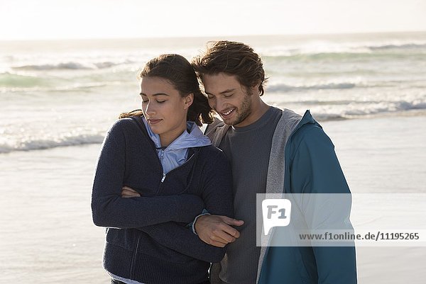Happy romantic young couple enjoying on beach