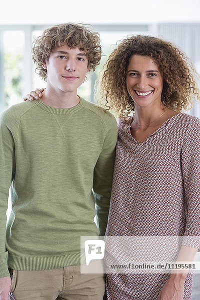 Portrait of happy mother and son at home