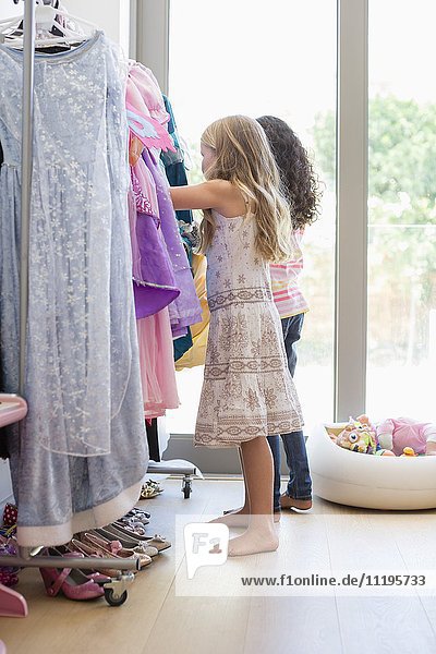 Two little girls shopping at clothing store