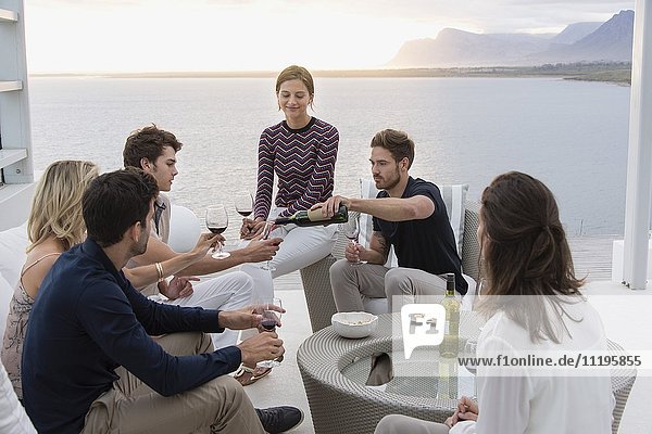 Group of friends enjoying wines at outdoors party