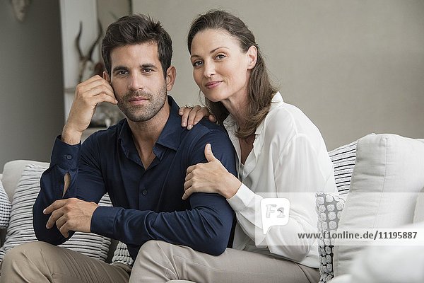 Portrait of a happy couple sitting on a couch