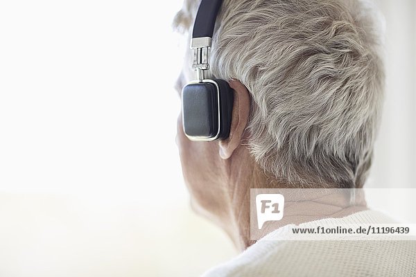 Senior man listening to music on headphones