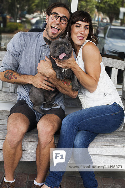 Caucasian couple imitating dog with tongue out