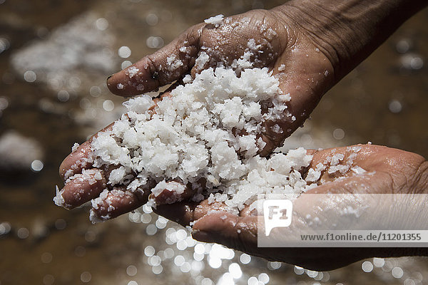Cropped image of hand holding natural salt