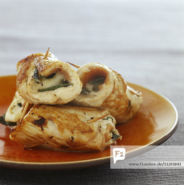 Small turkey fillet rolls garnished with marsala and sage