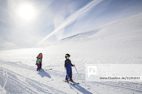 Mother with children skiing