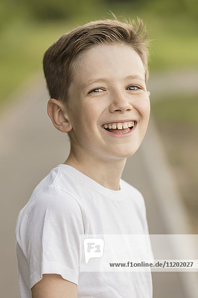 Portrait of cheerful boy at park
