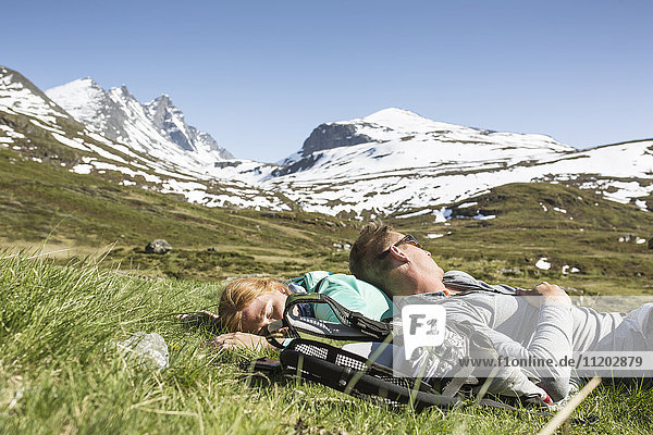 Hikers resting on meadow