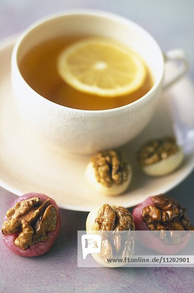 Caramelized walnut and almond paste bites and a cup of tea