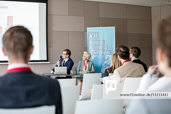 Businessman giving presentation in seminar hall