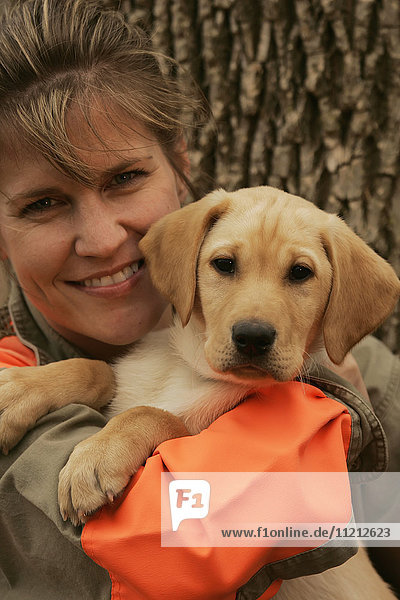 Female Upland Bird Hunter With Yellow Lab Puppy