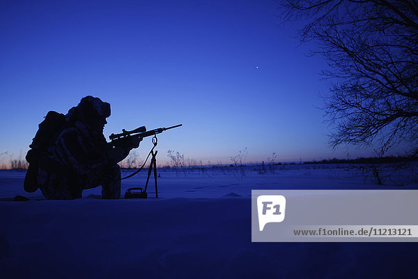 Silhouette Of Cold Weather Varmint Hunter
