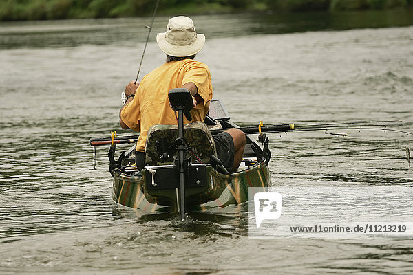 Man Fishes For Smallmouth Bass On River