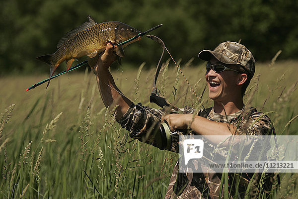 Man Bowfishing Carp