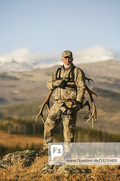 Big Game Hunter With Western Elk Rack On Back