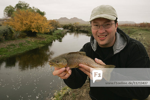 Fisherman With Brown Trout