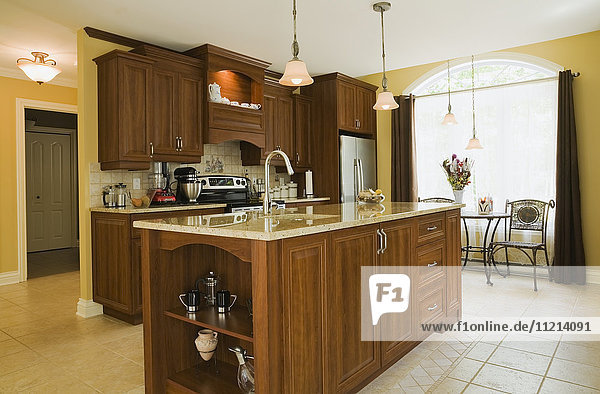 'Kitchen room with island inside a cottage style residential home; Quebec Canada'