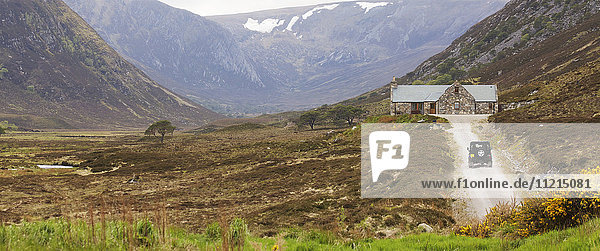 Cottage accommodation and Land Rover in Scottish Highland landscape  Scotland