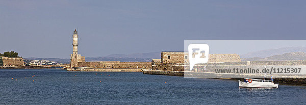 Der Leuchtturm und der historische venezianische Hafen mit Boot in der Altstadt von Chania  Kreta