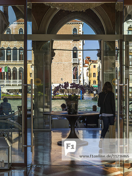 Blick von einer Lobby mit Glaswänden und einem dekorativen Tisch auf den Kanal draußen; Venedig  Italien