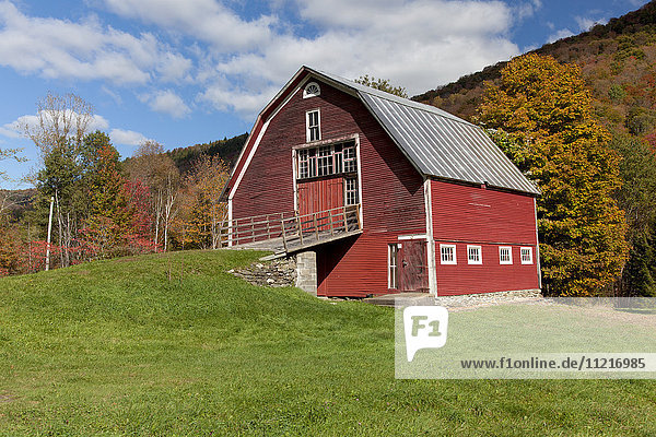 Red barn with blue sky along route 100 in autumn; Hancock  Vermont  United States of America