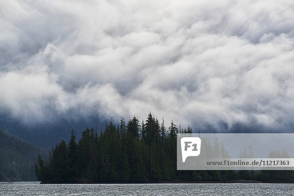 'Clouds billow over the coastal mountains; Haida Gwaii British Columbia Canada'
