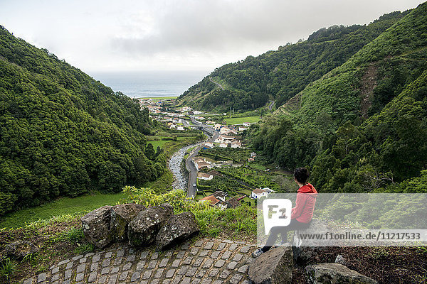 'Young woman enjoying the view in Faial da Terra; Sao Miguel  Azores  Portugal'
