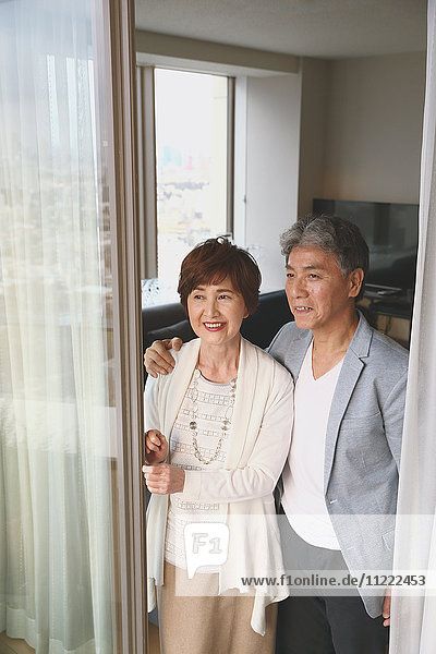 Fashionable Japanese senior couple by the window