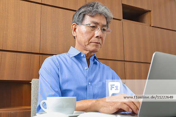 Fashionable Japanese senior man working