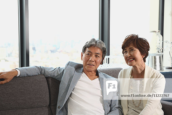 Fashionable Japanese senior couple on the sofa