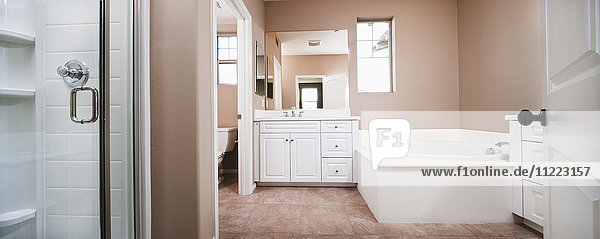 Bathroom with bath and cabinets at mirror